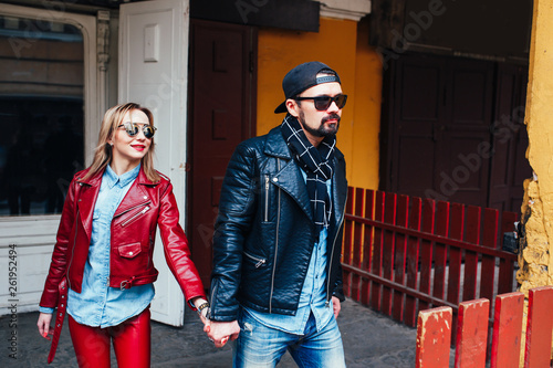 Sexy couple in leather jacket and sunglasses walking in city street © Elena Kratovich
