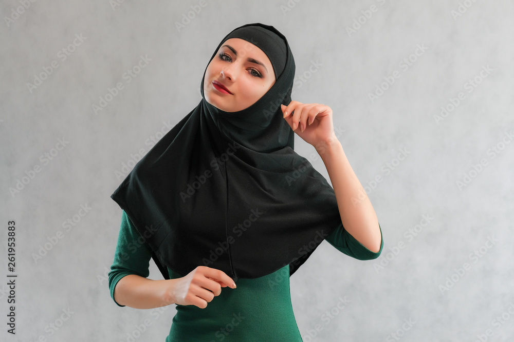 Concept Beauty sexy fashion model woman in hijab portrait, with long beautiful hair on black background standing. Beautiful young brunette girl posing in studio. Concept Beauty sexy fashion model woman in hijab portrait, with long beautiful hair on black background standing. Beautiful young brunette girl posing in studio.