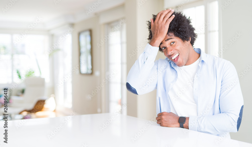 African American man at home surprised with hand on head for mistake, remember error. Forgot, bad memory concept. African American man at home surprised with hand on head for mistake, remember error. Forgot, bad memory concept.