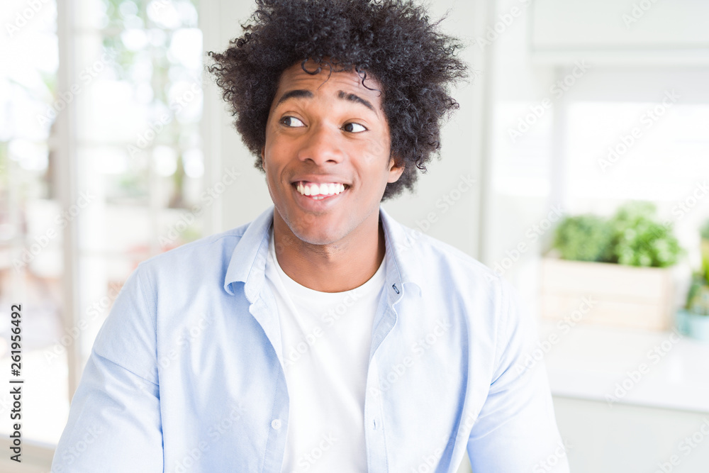 African American man at home smiling looking side and staring away thinking. African American man at home smiling looking side and staring away thinking.