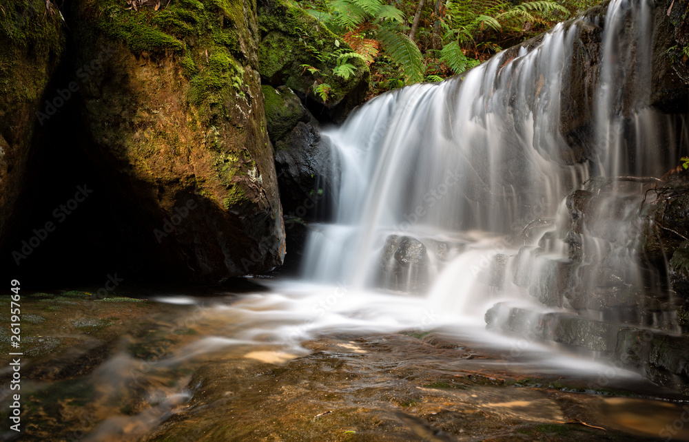 Waterfall in lush mountain gully Waterfall in lush mountain gully