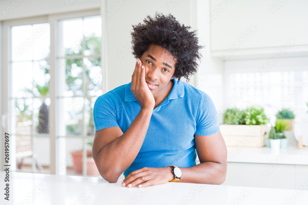 African American man at home thinking looking tired and bored with depression problems with crossed arms. African American man at home thinking looking tired and bored with depression problems with crossed arms.