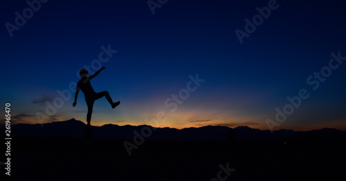 Silhouette of man doing walking at sunset, Concept lifestyle freedom vacation travel.