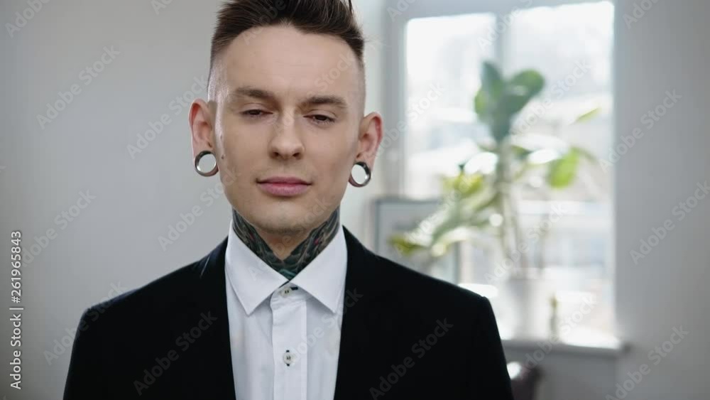 Portrait of alternative model with earplugs and tattoo