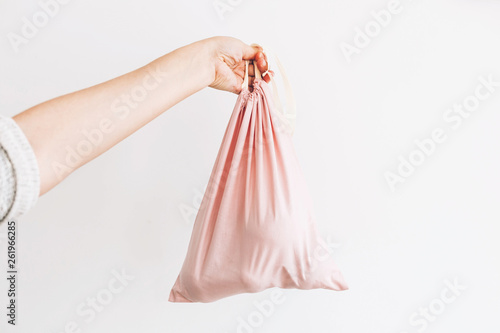 Ban single use plastic. Woman holding in hand groceries in reusable eco bag. Zero Waste shopping concept. Choose eco friendly natural bags. Sustainable lifestyle. Reuse, reduce, refuse