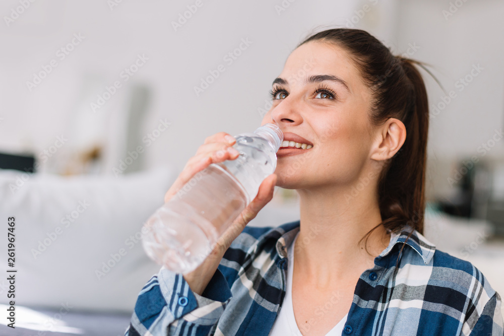 Girl holding a bottle of water. Smiling girl drinking water. Girl holding a bottle of water. Smiling girl drinking water.
