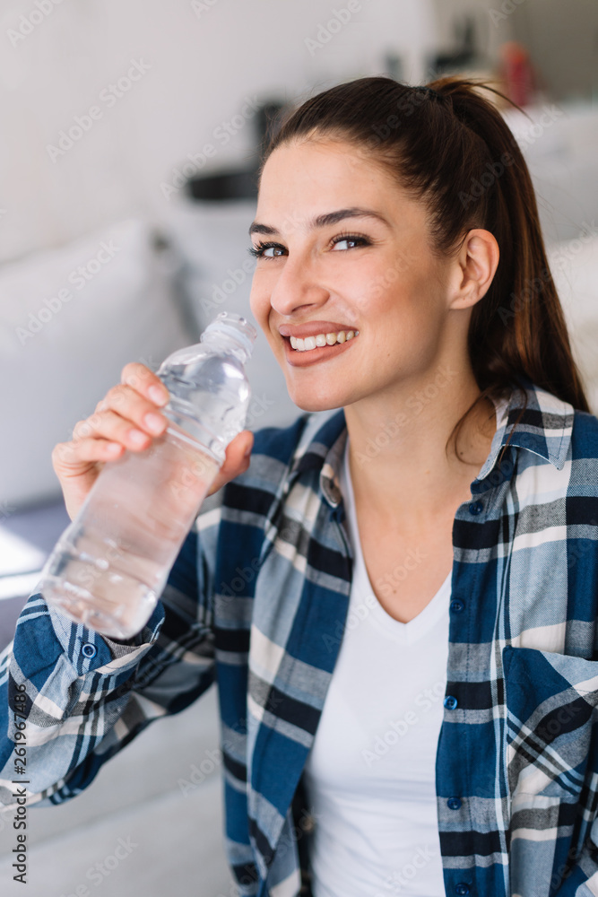 Girl holding a bottle of water. Smiling girl drinking water. Girl holding a bottle of water. Smiling girl drinking water.