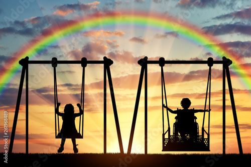 Happy child is a disabled person in a wheelchair riding an adaptive swing next to a healthy child together