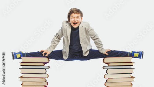 concept with cute kid doing splits on the books photo