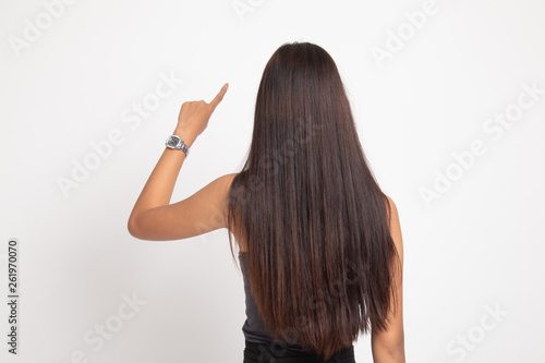 Back of Asian woman touching the screen with her finger.