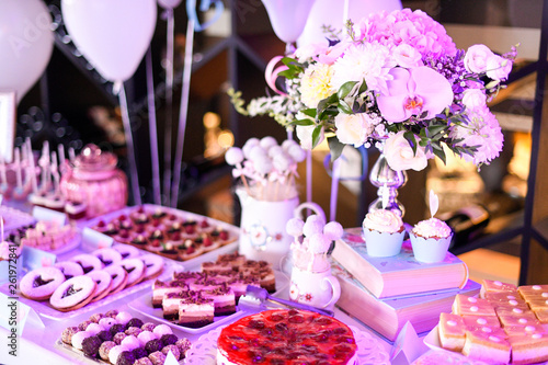 Delicious candy bar with cupcakes, cake pops, macaroons and other sweets