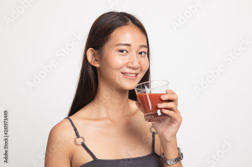 Young Asian woman drink tomato juice.