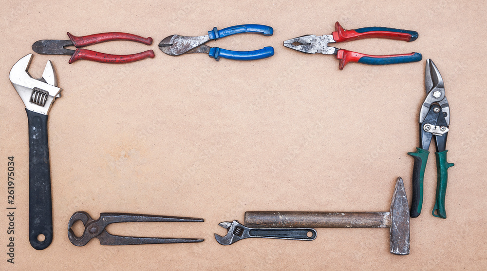 Old dirty tools on wooden background. Construction industry concept Old dirty tools on wooden background. Construction industry concept