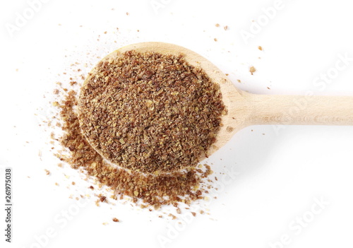 Ground, milled flaxseed, linseed with wooden spoon isolated on white background