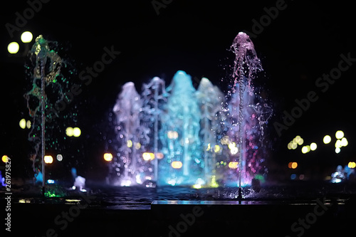colorful night fountains / jets of colored water in a fountain, night illumination in the city, tourist object art