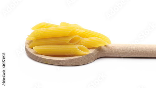 Penne rigate pasta pile with wooden spoon isolated on white background