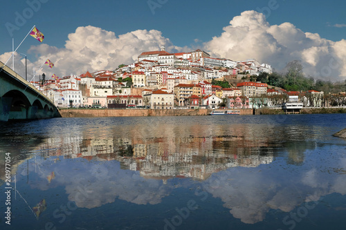 The university city of Coimbra in Portugal. Cityscape. The old town is reflected in the water of the river.