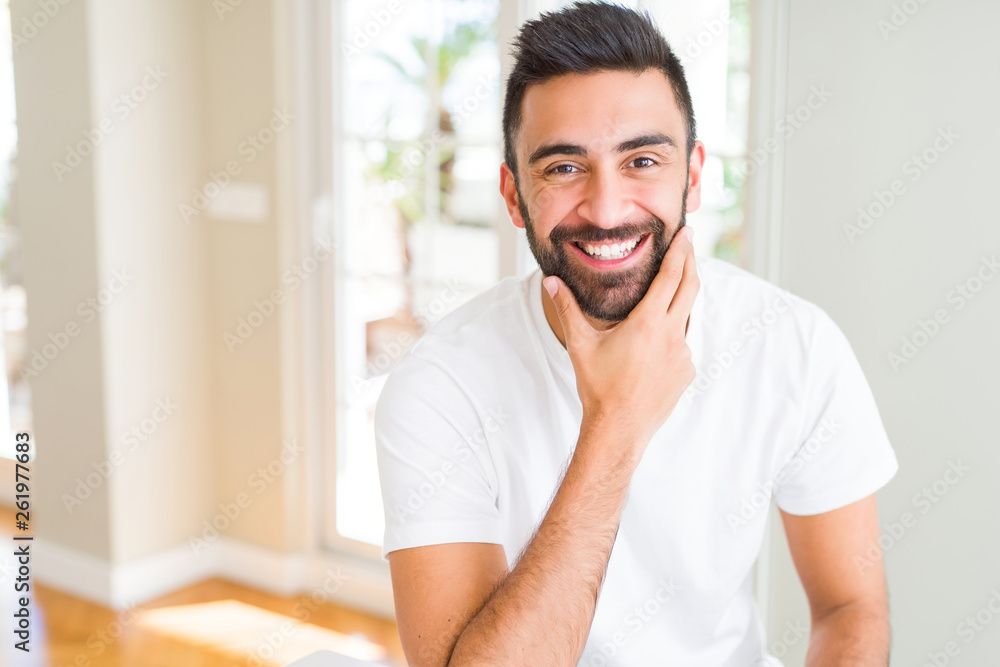 Handsome man smiling cheerful with a big smile on face showing teeth, positive and happy expression Handsome man smiling cheerful with a big smile on face showing teeth, positive and happy expression