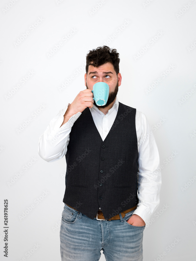 handsome, young man with black beard posing with turquoise coffee cup or tea cup in front of white background and making different facial expressions handsome, young man with black beard posing with turquoise coffee cup or tea cup in front of white background and making different facial expressions