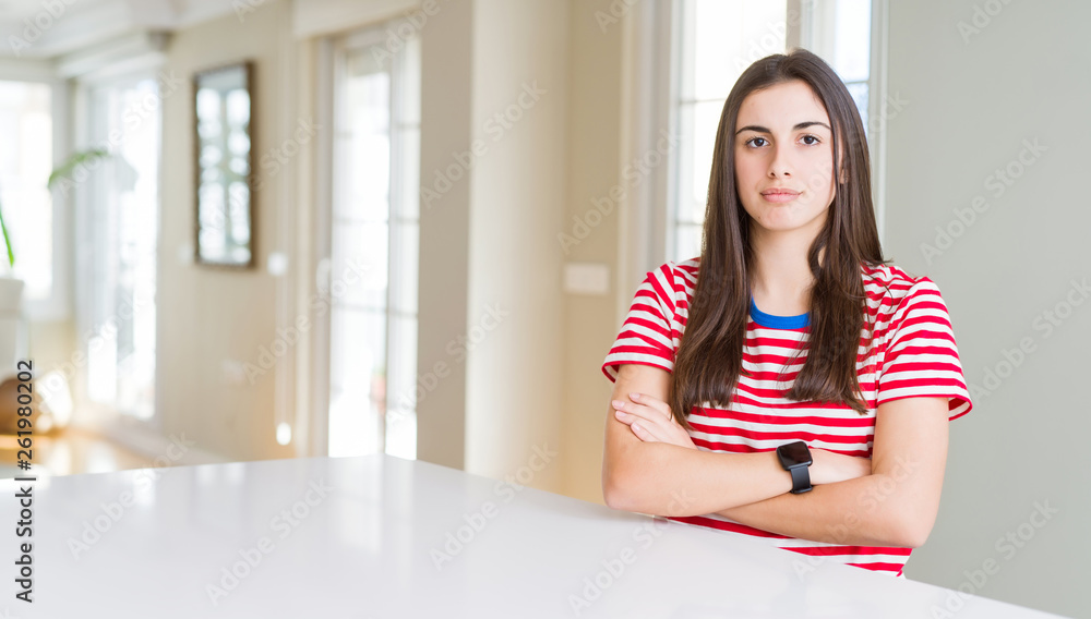 Beautiful young woman wearing casual stripes t-shirt skeptic and nervous, disapproving expression on face with crossed arms. Negative person. Beautiful young woman wearing casual stripes t-shirt skeptic and nervous, disapproving expression on face with crossed arms. Negative person.