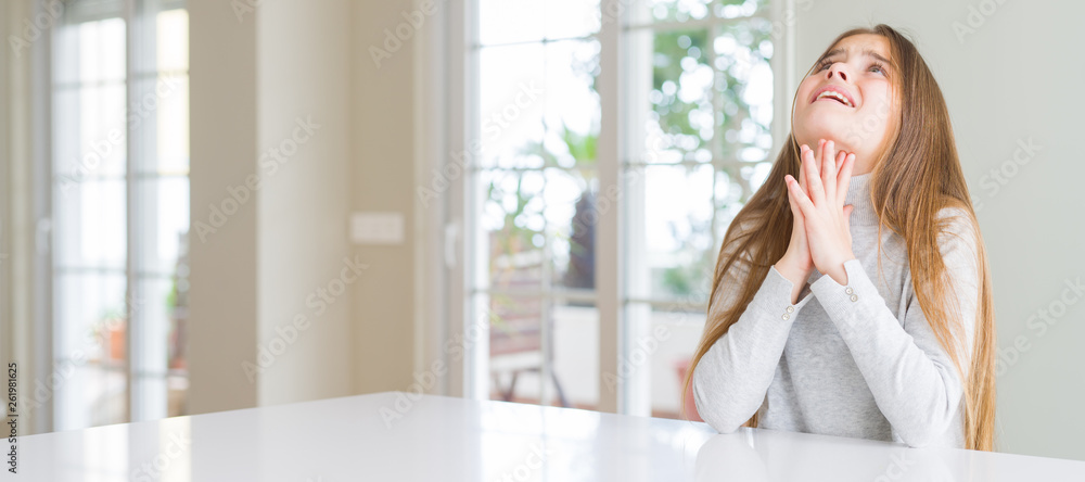 Wide angle picture of beautiful young girl kid wearing casual sweater begging and praying with hands together with hope expression on face very emotional and worried. Asking for forgiveness Wide angle picture of beautiful young girl kid wearing casual sweater begging and praying with hands together with hope expression on face very emotional and worried. Asking for forgiveness