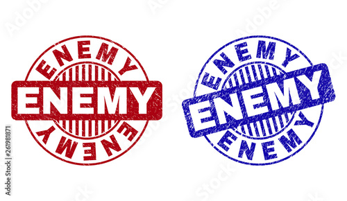 Grunge ENEMY round watermarks isolated on a white background. Round seals with grunge texture in red and blue colors. Vector rubber imitation of ENEMY text inside circle form with stripes.