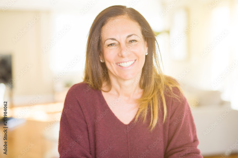 Beautiful middle age woman smiling at home Beautiful middle age woman smiling at home