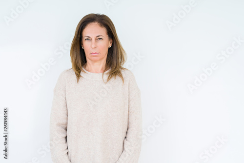 Beautiful middle age woman over isolated background skeptic and nervous, frowning upset because of problem. Negative person.