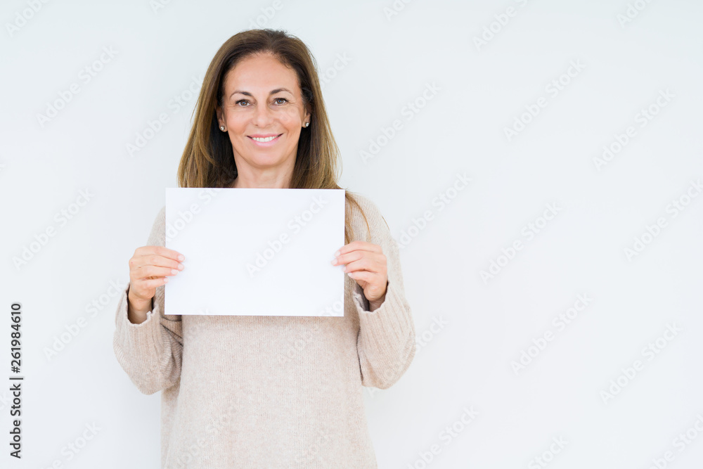 Middle age woman holding blank paper sheet over isolated background with a happy face standing and smiling with a confident smile showing teeth Middle age woman holding blank paper sheet over isolated background with a happy face standing and smiling with a confident smile showing teeth