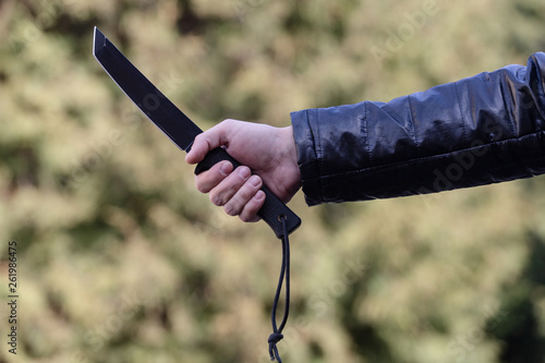 A big black knife in a man's hand