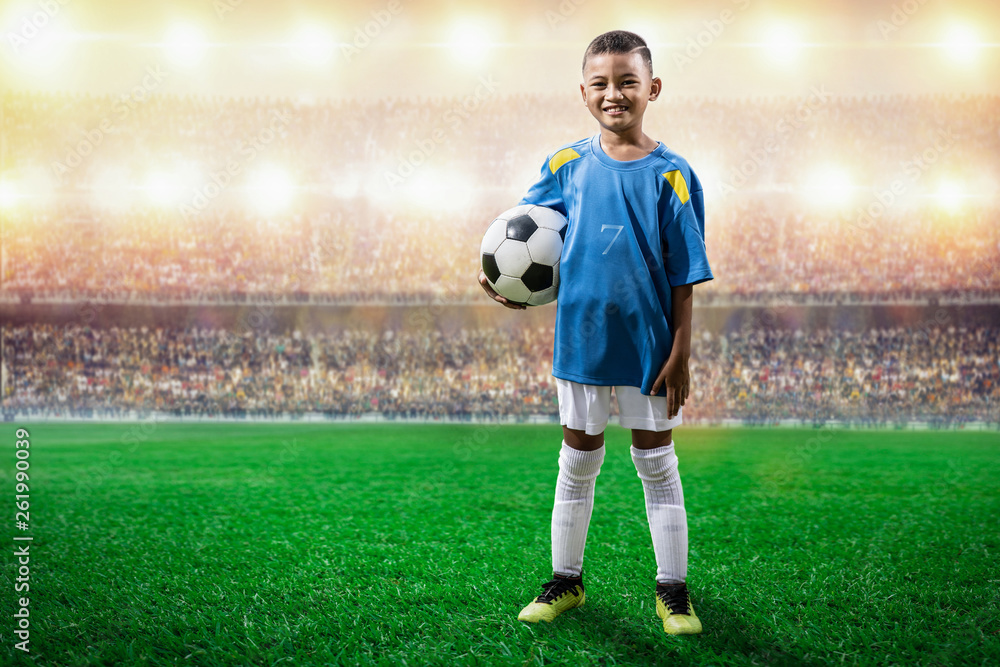 asian soccer kids player in blue jersey standing and pose to camera in the  stadium Stock Photo | Adobe Stock