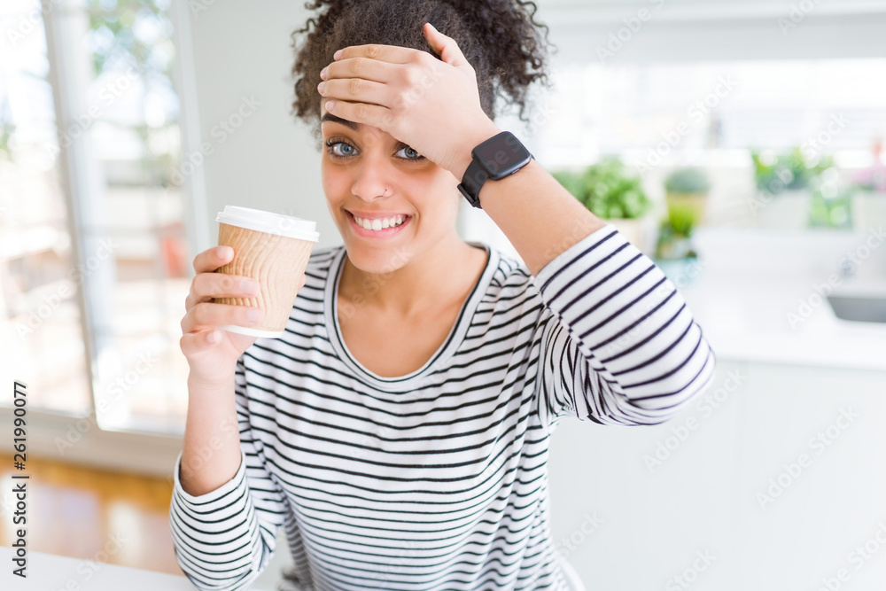 Young african american girl drinking a coffee on a take away paper cup stressed with hand on head, shocked with shame and surprise face, angry and frustrated. Fear and upset for mistake. Young african american girl drinking a coffee on a take away paper cup stressed with hand on head, shocked with shame and surprise face, angry and frustrated. Fear and upset for mistake.
