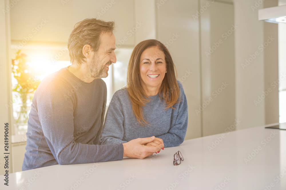 Romantic middle age couple sitting together at home Romantic middle age couple sitting together at home
