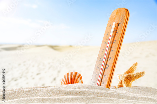 thermometer on sand and beach landscape 