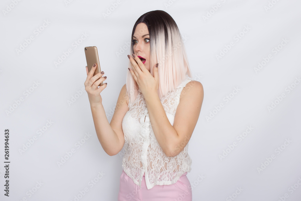 Blonde woman holding mobile phone Blonde woman holding mobile phone