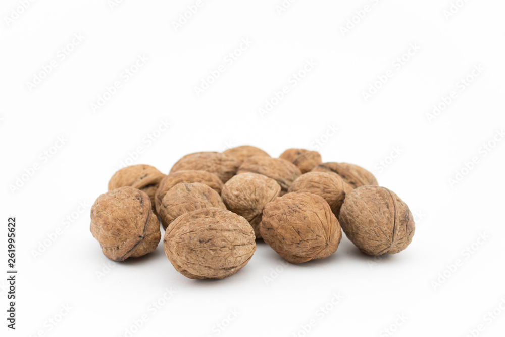 Walnuts on white background. The health benefits of walnuts are many. Walnuts on white background. The health benefits of walnuts are many.