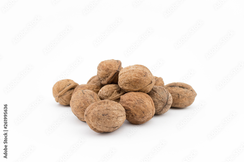 Walnuts on white background. The health benefits of walnuts are many. Walnuts on white background. The health benefits of walnuts are many.