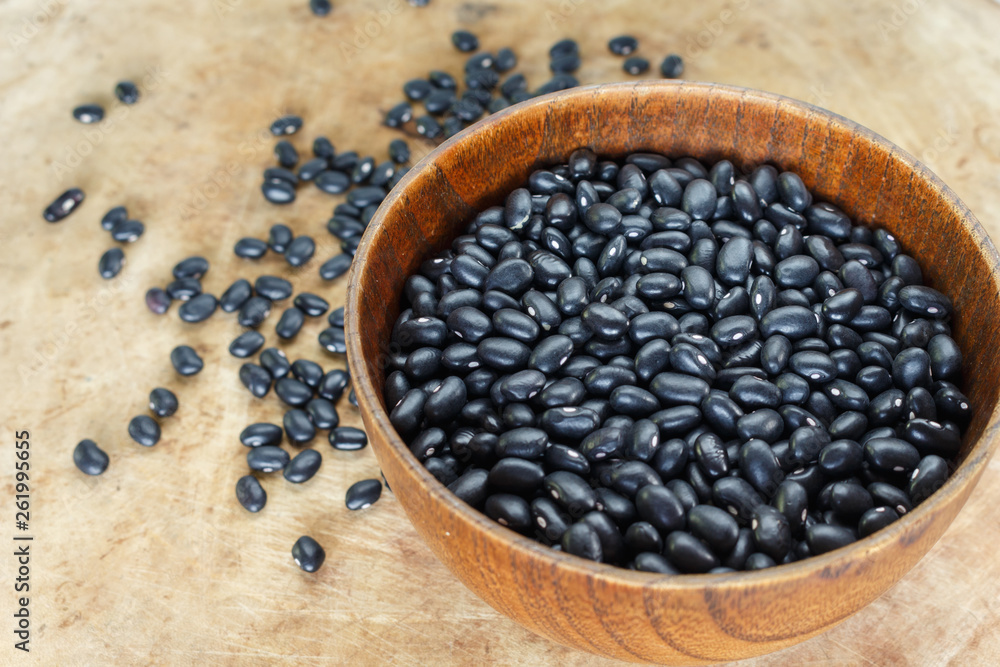 Black bean in bowl on wooden background. Black bean in bowl on wooden background.