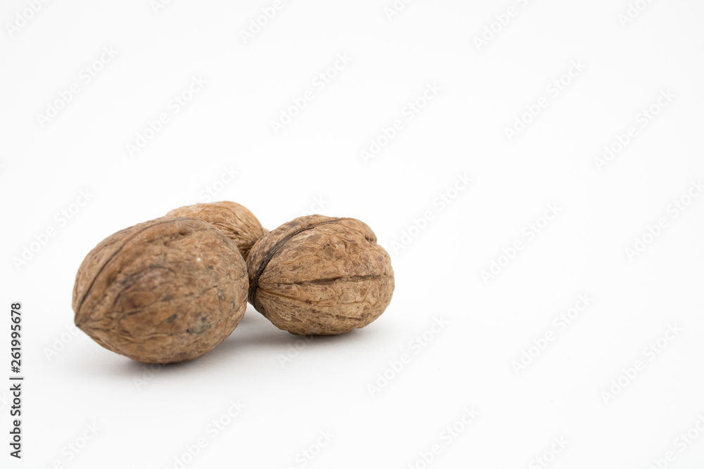 Walnuts on white background. The health benefits of walnuts are many. Walnuts on white background. The health benefits of walnuts are many.