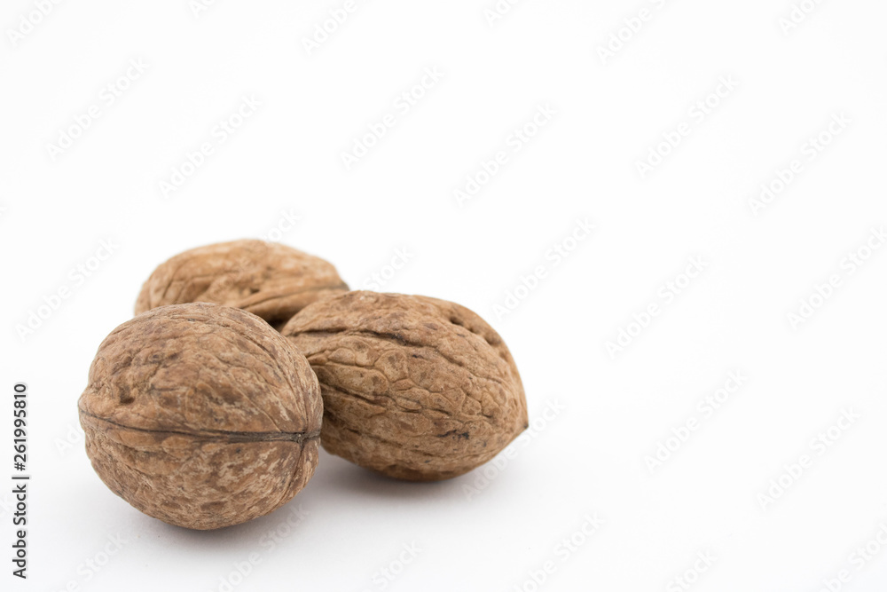 Walnuts on white background. The health benefits of walnuts are many. Walnuts on white background. The health benefits of walnuts are many.