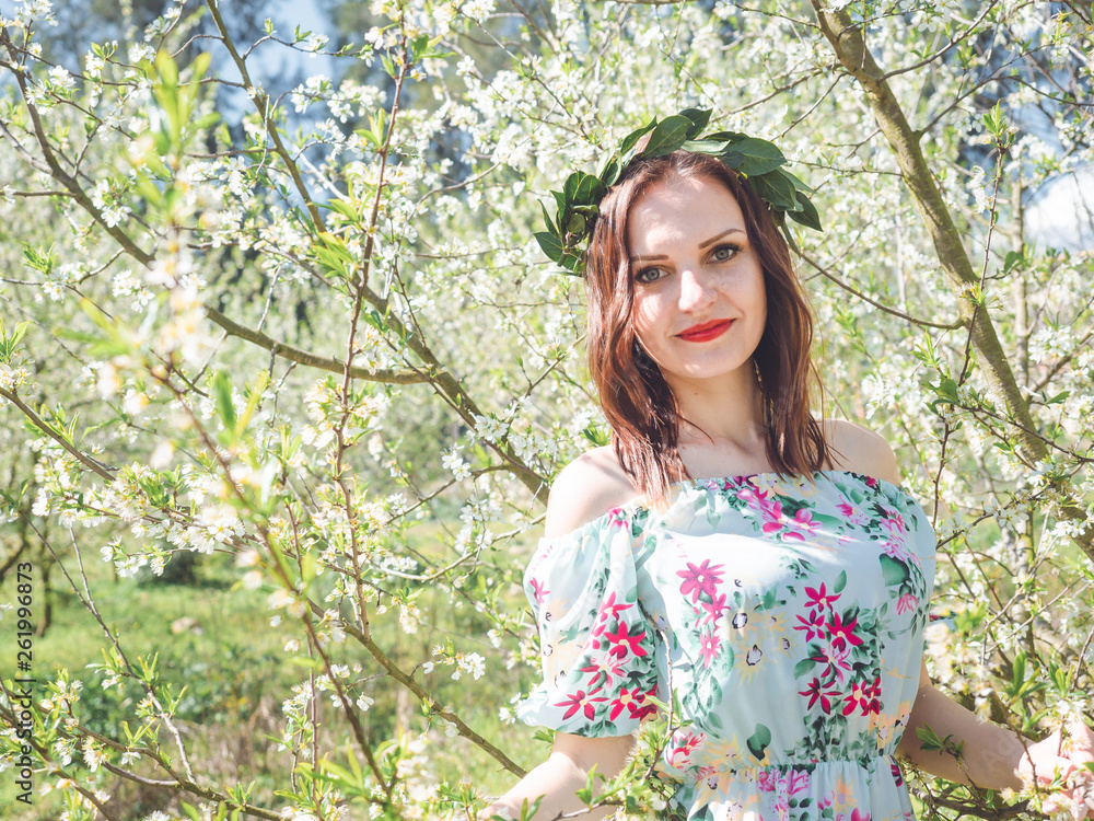 Young beautiful smiling woman in spring blossom trees. Young beautiful smiling woman in spring blossom trees.