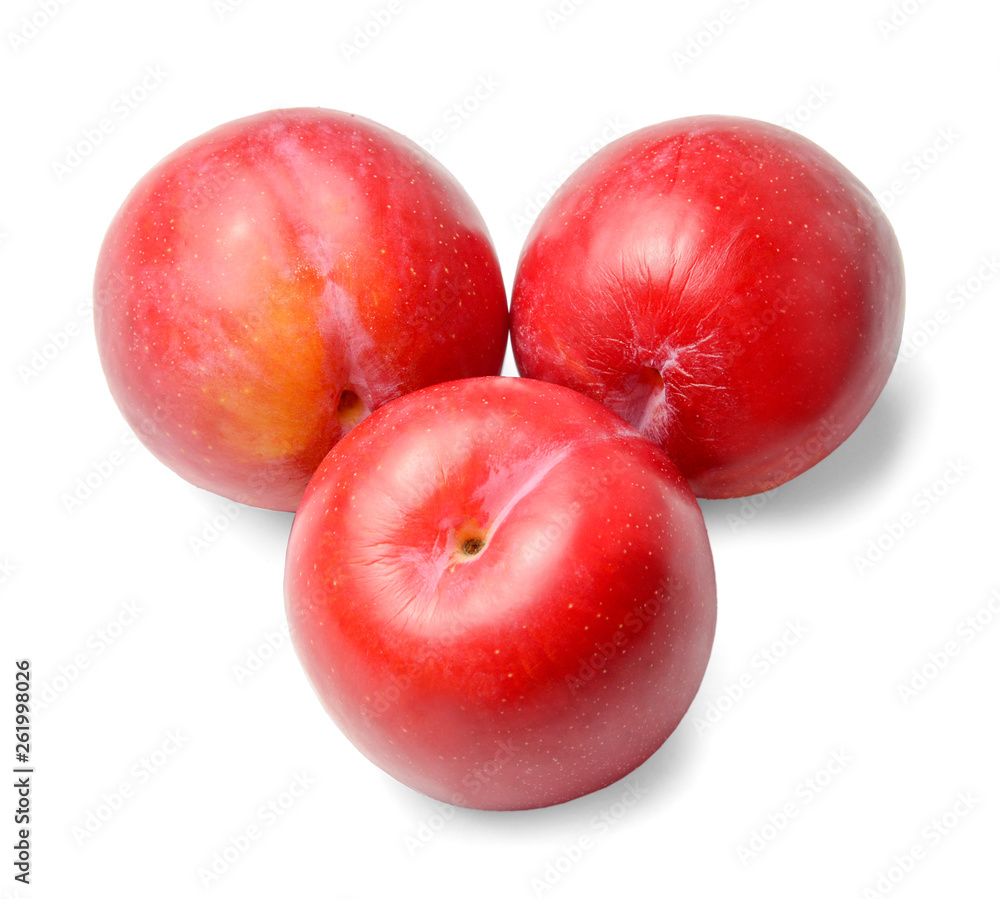 Three ripe red round plums isolated on white. Close-up. View from above.
