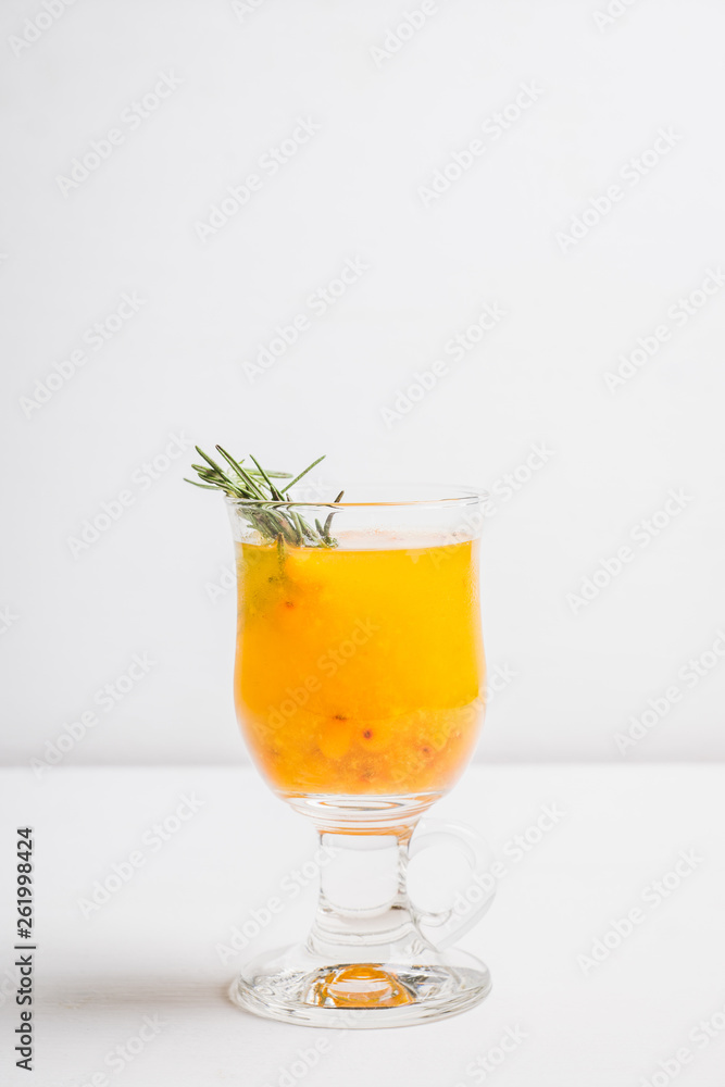 Hot buckthorn beverage in glass. Selective focus. Shallow depth of field. Hot buckthorn beverage in glass. Selective focus. Shallow depth of field.