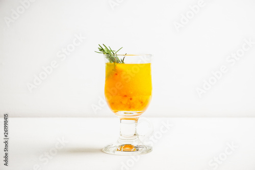 Hot buckthorn beverage in glass. Selective focus. Shallow depth of field. 