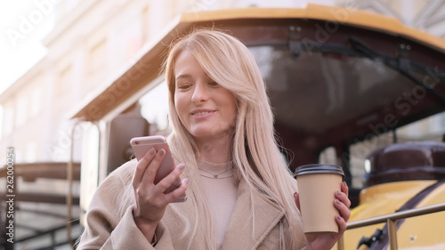 Stylish happy hipster girl using modern smartphone device.