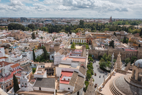 Aerial view of the Cathedral of Saint Mary of the See (Seville Cathedral) in Seville, Andalusia, Spain in a sunny and cloudy day.