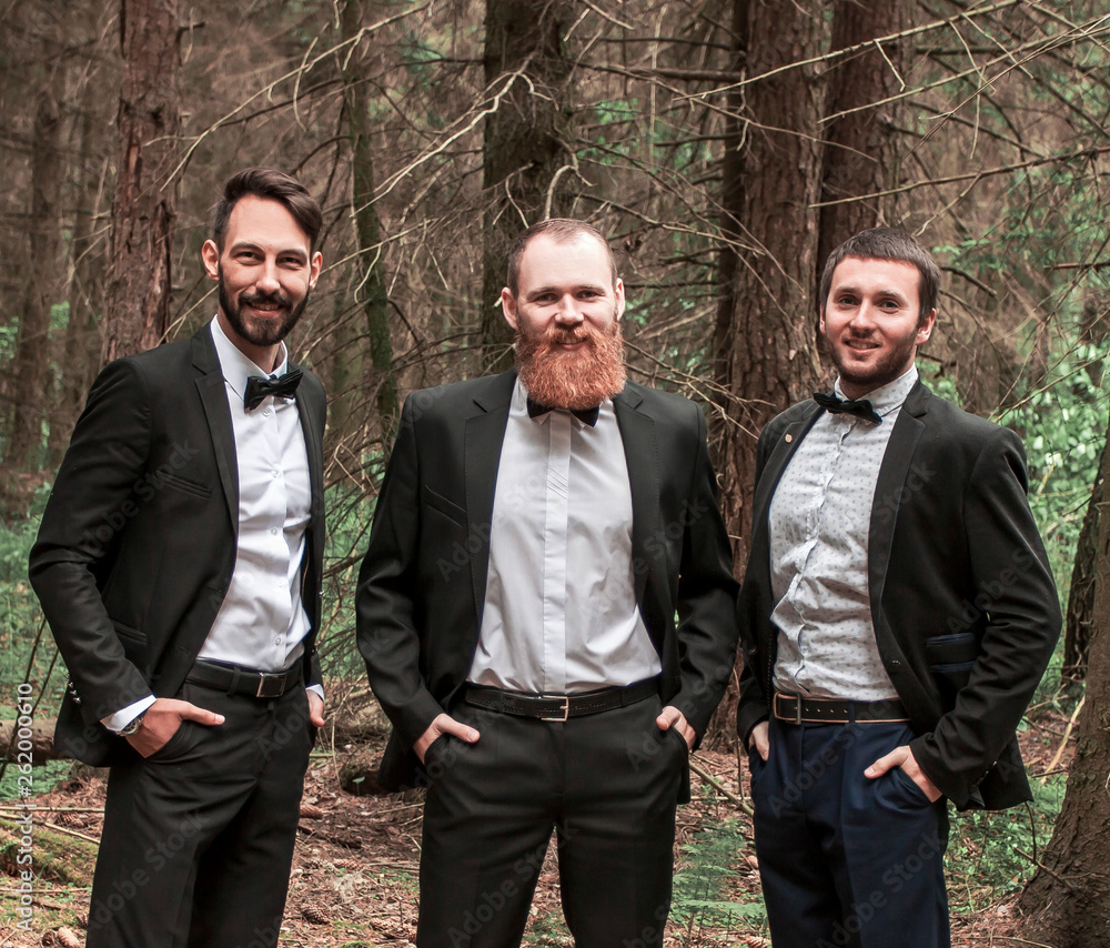 portrait of three business partners on the background of the forest. portrait of three business partners on the background of the forest.