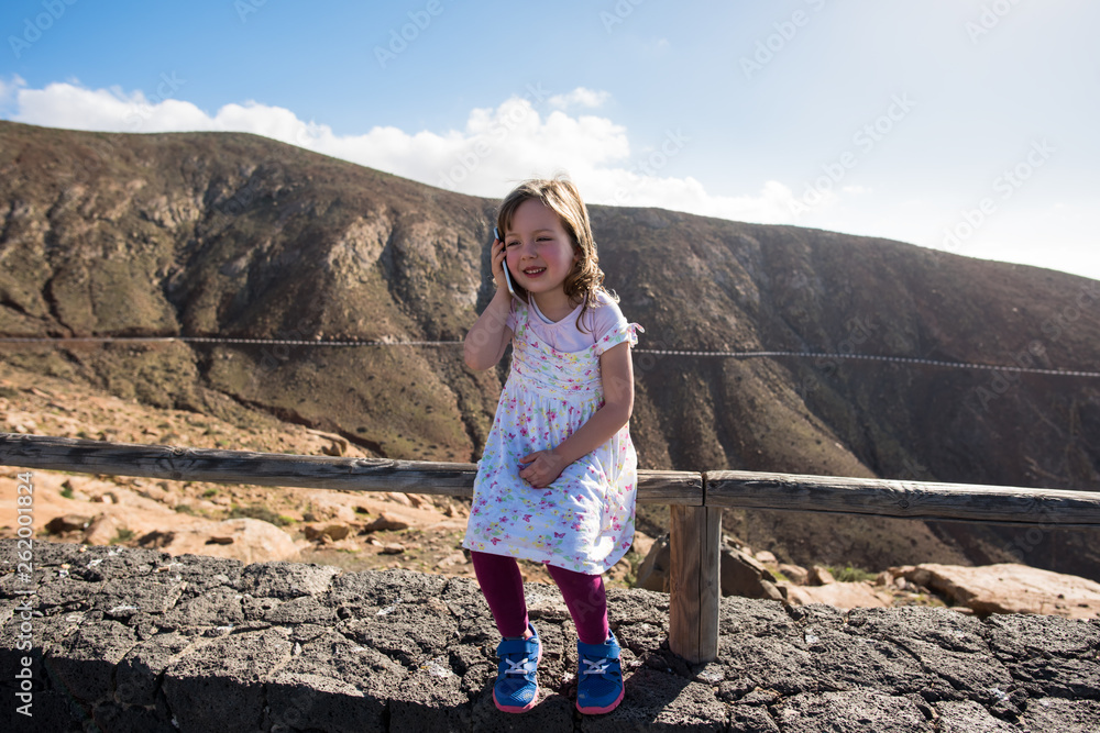 Naklejka premium Little girl calling in mountains