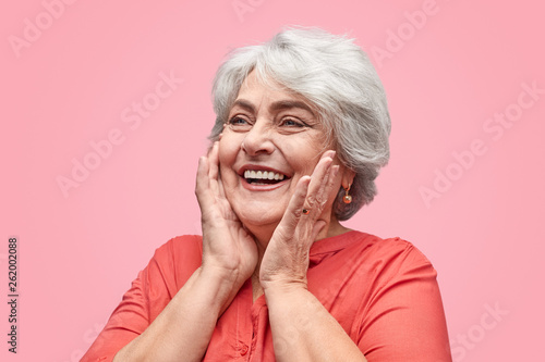 Excited elderly woman looking away