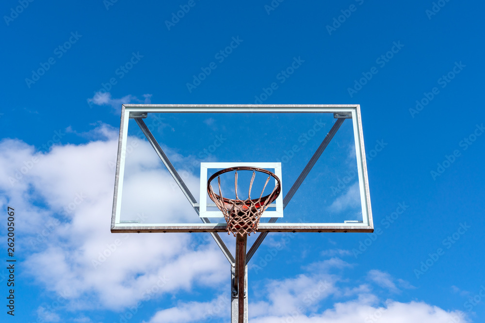 Basketball hoop against blue sky